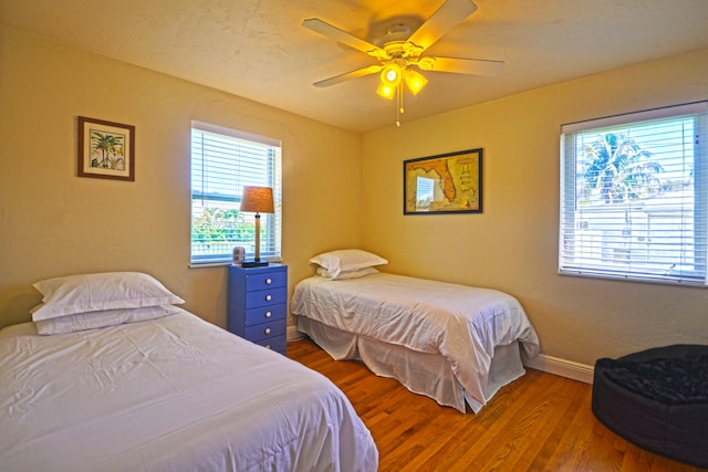 bedroom featuring wood-type flooring and ceiling fan