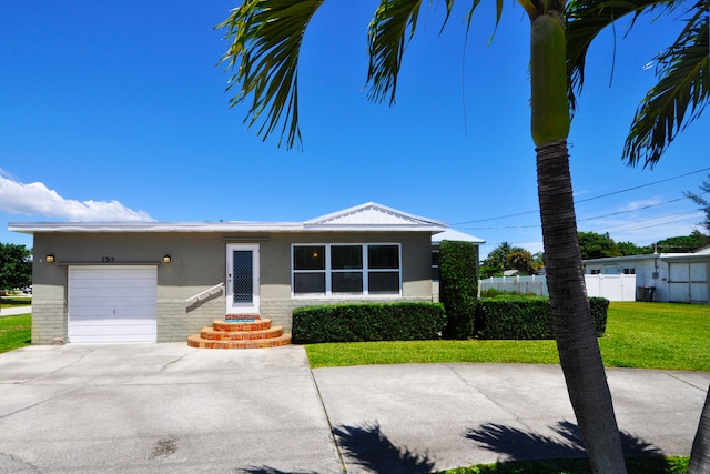 view of front of home with a garage and a front lawn