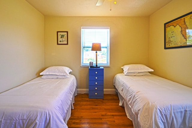 bedroom with ceiling fan and dark hardwood / wood-style floors