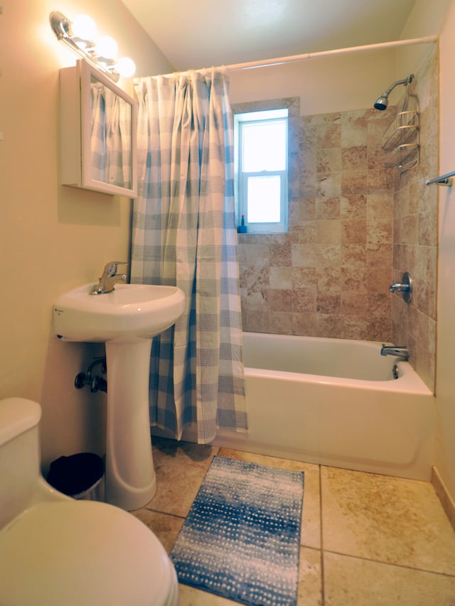 bathroom with toilet, tile patterned flooring, and shower / bath combination with curtain