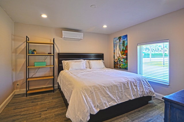 bedroom with an AC wall unit and dark hardwood / wood-style floors