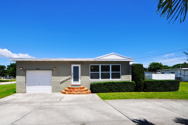 view of front of house with a garage and a front yard