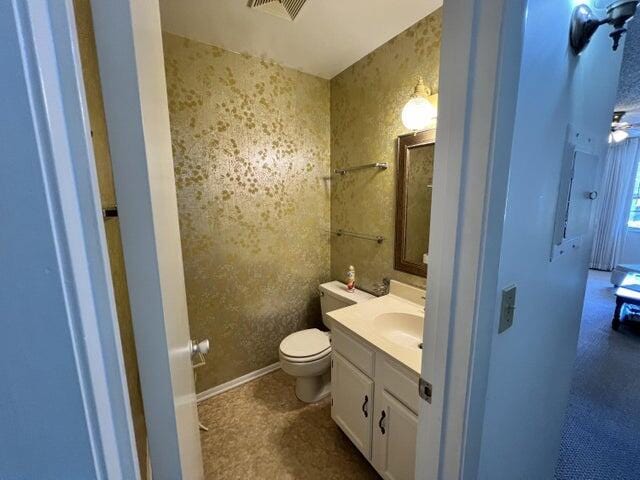 bathroom featuring toilet and vanity