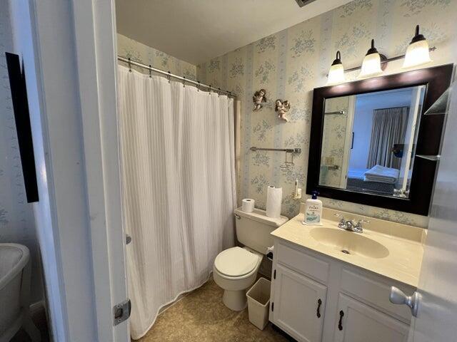 bathroom featuring toilet and vanity