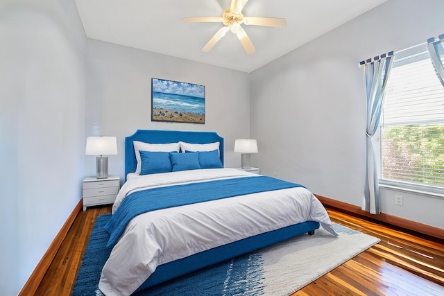 655 NE Emerson St, Port Saint Lucie, FL 34983 - bedroom with wood-type flooring, baseboards, and ceiling fan