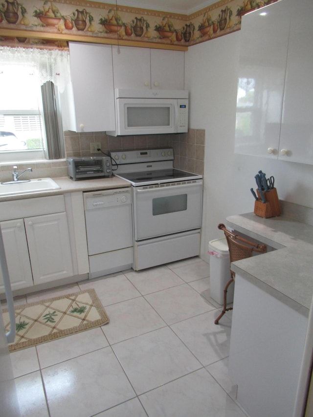 kitchen with sink, white appliances, backsplash, white cabinets, and light tile patterned flooring