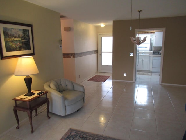 living area featuring sink and light tile patterned floors