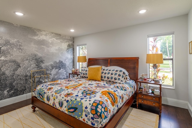 bedroom featuring multiple windows and dark wood-type flooring