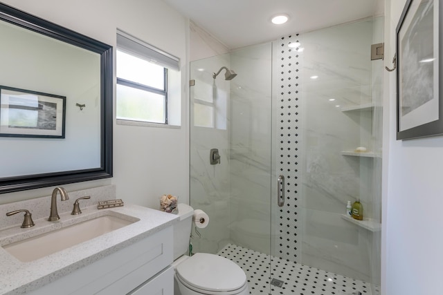 bathroom featuring vanity, an enclosed shower, and toilet