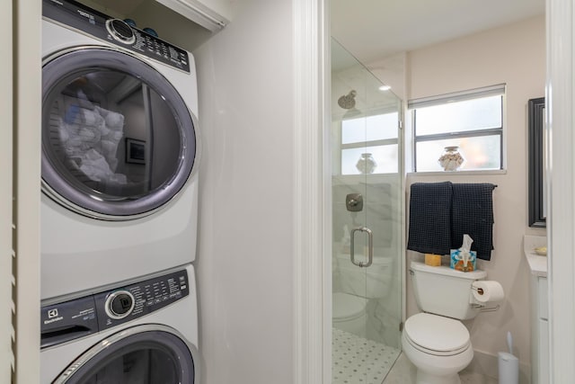 3593 Crab Apple Trl Unit C, Lake Worth, FL 33467 - bathroom featuring stacked washer / dryer, a shower stall, and toilet