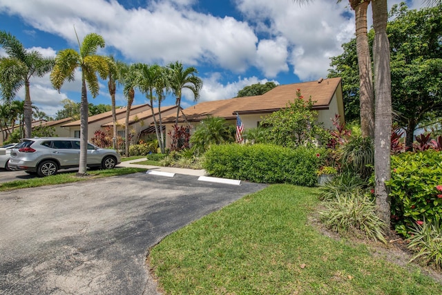 3593 Crab Apple Trl Unit C, Lake Worth, FL 33467 - view of front of house with uncovered parking, stucco siding, and a front yard