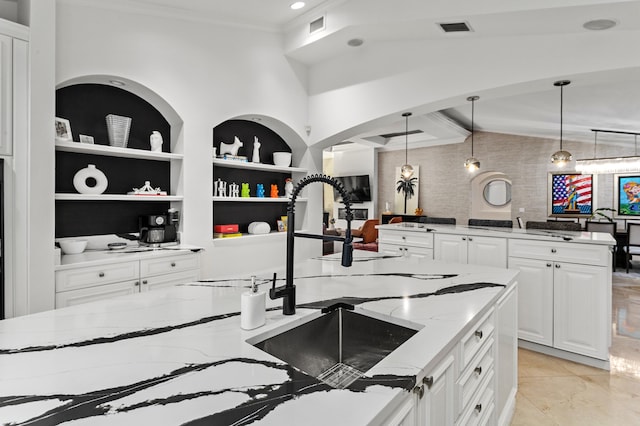 kitchen with built in features, white cabinetry, light tile patterned floors, and light stone countertops