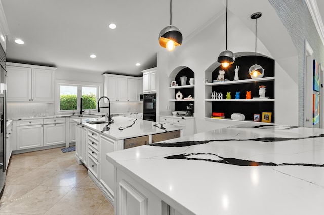 kitchen featuring hanging light fixtures, white cabinets, ornamental molding, and light stone countertops