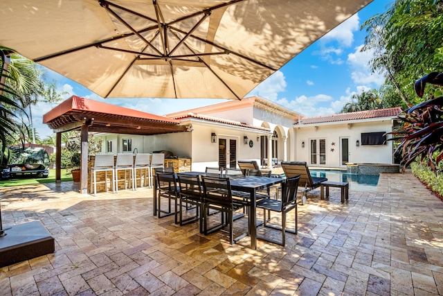 view of patio / terrace with an outdoor bar and french doors