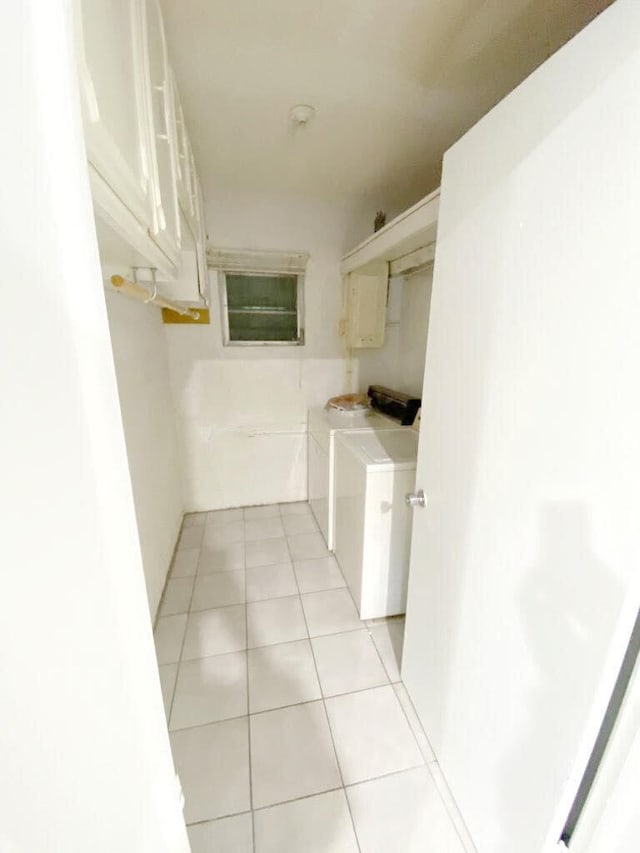 interior space featuring light tile patterned flooring and washer / dryer