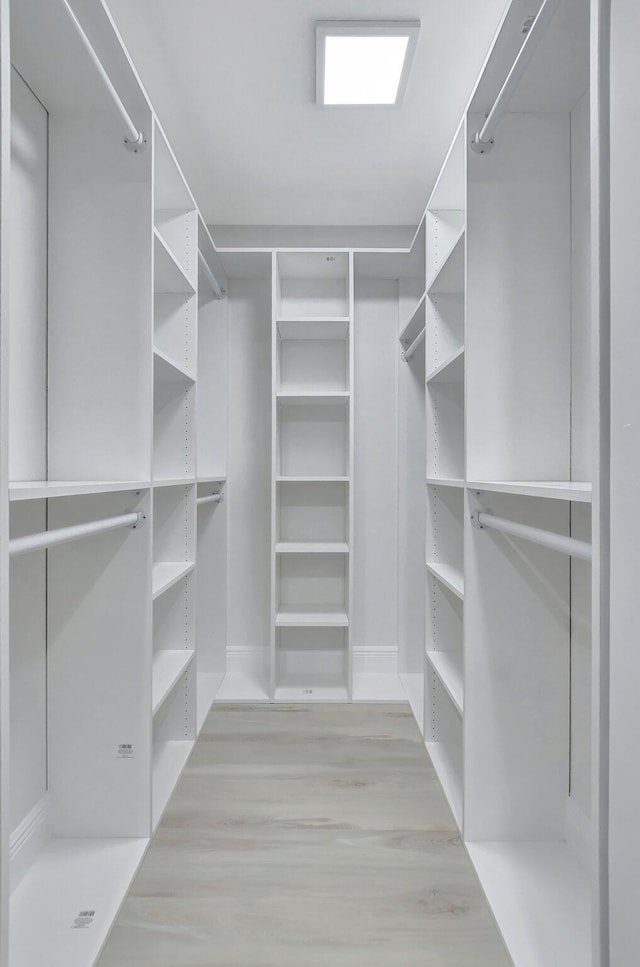 spacious closet with light hardwood / wood-style floors