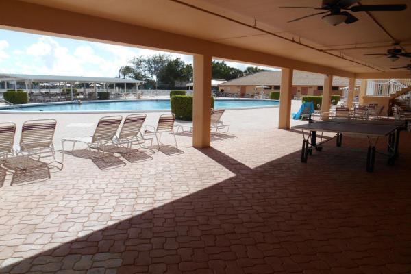 view of swimming pool with ceiling fan and a patio area