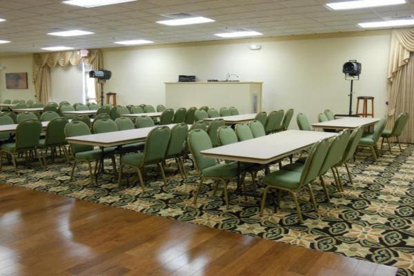 dining area with a paneled ceiling and hardwood / wood-style floors