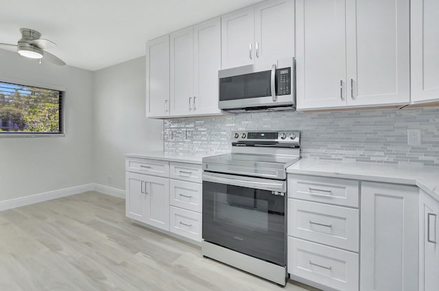 kitchen featuring ceiling fan, backsplash, white cabinets, and stainless steel appliances