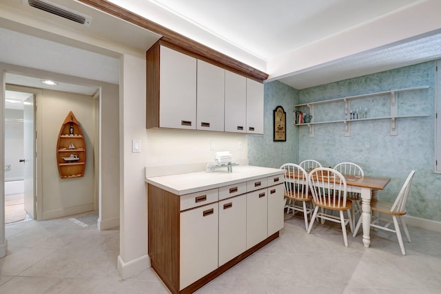 kitchen featuring white cabinets and light tile patterned floors