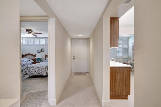 hall with light tile patterned flooring