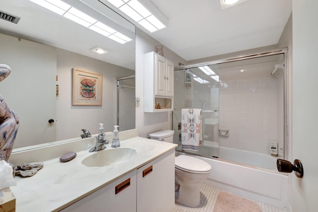 full bathroom with vanity, tile patterned flooring, shower / bath combination with glass door, and toilet