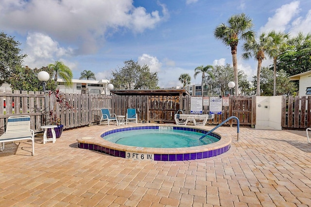 view of swimming pool featuring a community hot tub and a patio