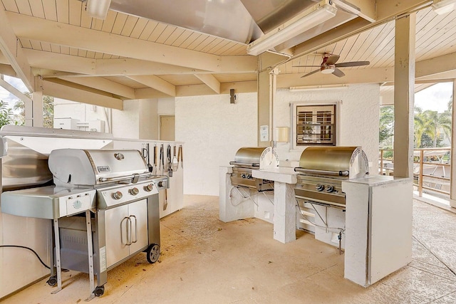 view of patio / terrace with ceiling fan, area for grilling, and exterior kitchen