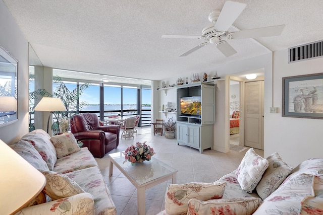 living room with floor to ceiling windows, a textured ceiling, light tile patterned floors, and ceiling fan