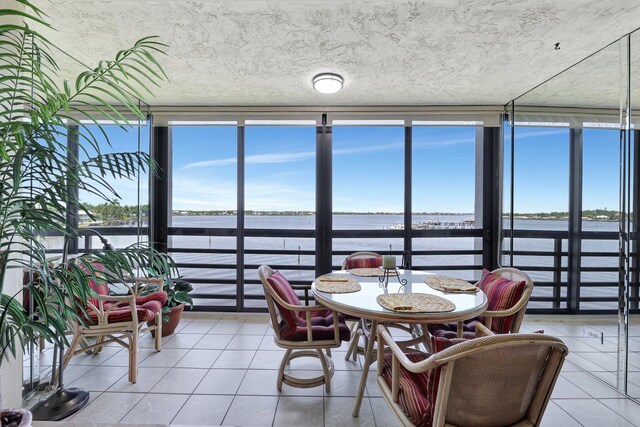 sunroom / solarium with plenty of natural light and a water view