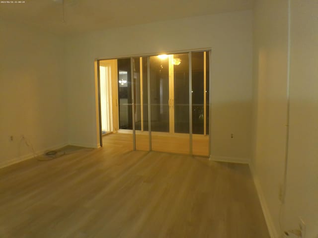 unfurnished room with wood-type flooring