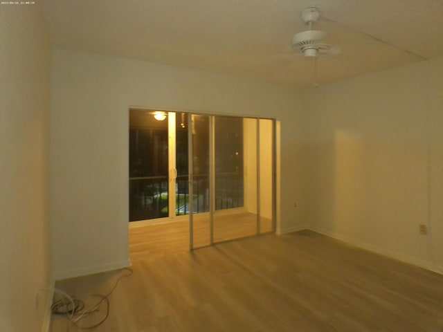 unfurnished room with ceiling fan and wood-type flooring