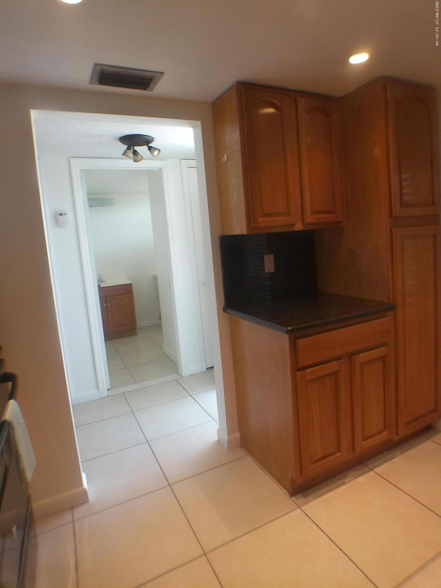 9872 Marina Blvd Unit 1434, Boca Raton, FL 33433 - kitchen with recessed lighting, light tile patterned floors, and brown cabinets