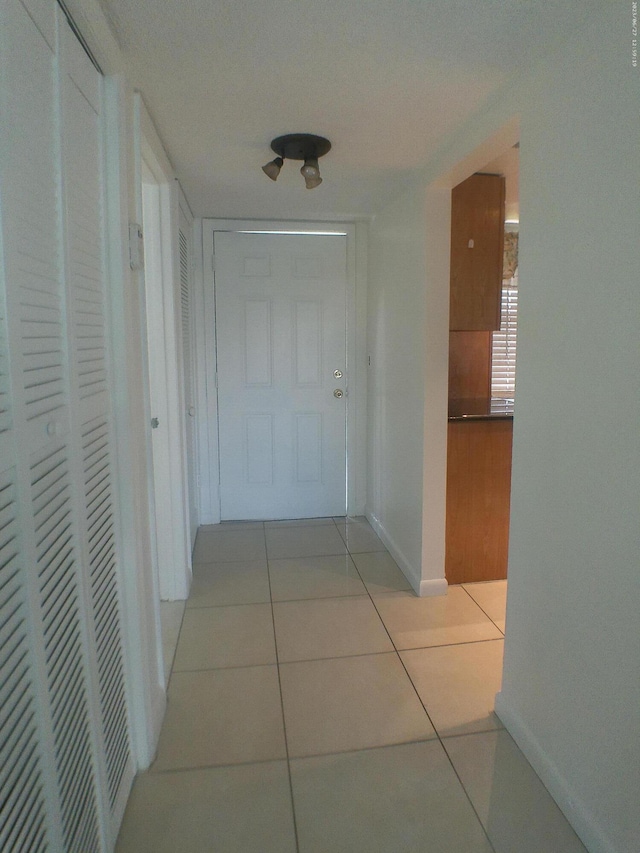 9872 Marina Blvd Unit 1434, Boca Raton, FL 33433 - corridor with light tile patterned floors and baseboards