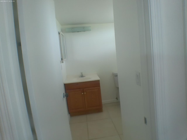 bathroom featuring tile patterned floors, toilet, and vanity