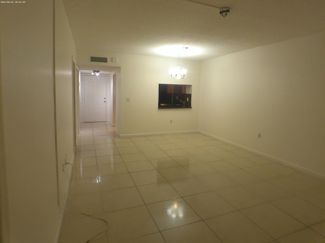 9872 Marina Blvd Unit 1434, Boca Raton, FL 33433 - empty room with light tile patterned flooring, a chandelier, and a textured ceiling