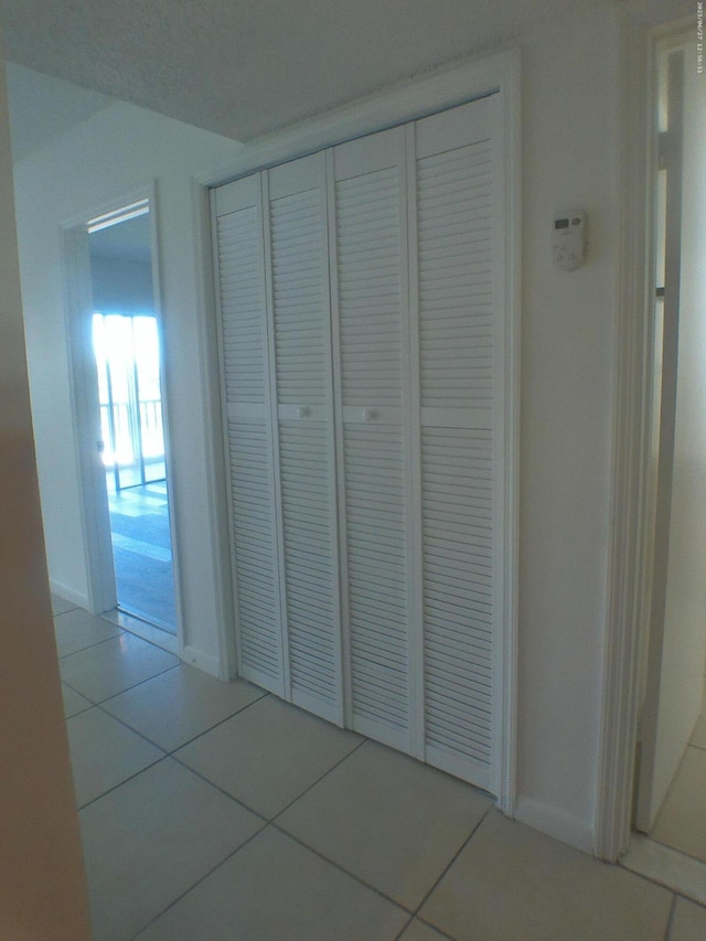 9872 Marina Blvd Unit 1434, Boca Raton, FL 33433 - hall featuring tile patterned floors and baseboards