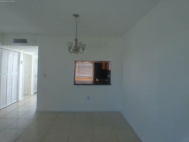 9872 Marina Blvd Unit 1434, Boca Raton, FL 33433 - empty room with a chandelier and light tile patterned flooring