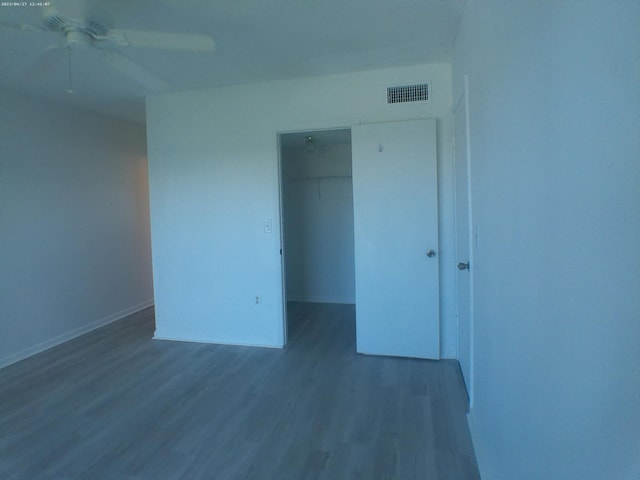 9872 Marina Blvd Unit 1434, Boca Raton, FL 33433 - unfurnished bedroom with wood finished floors, a closet, a spacious closet, and a ceiling fan