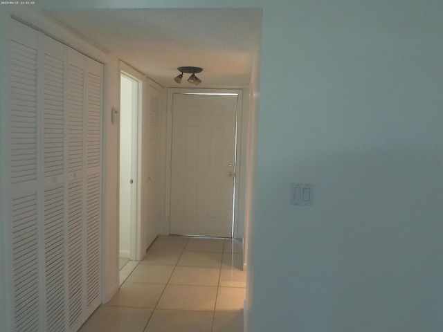 hallway with light tile patterned floors