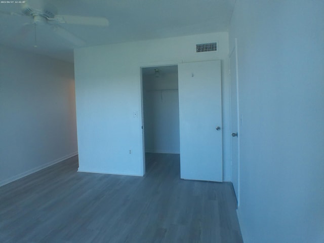 empty room featuring ceiling fan and dark wood-type flooring