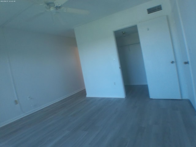 unfurnished bedroom featuring wood-type flooring and ceiling fan