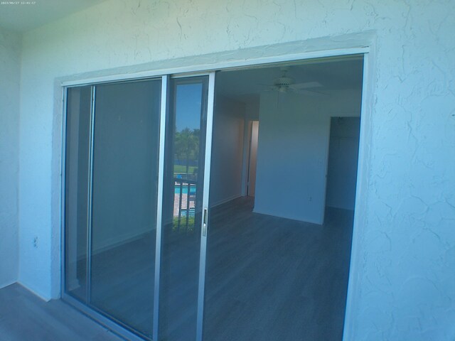 entrance to property featuring ceiling fan