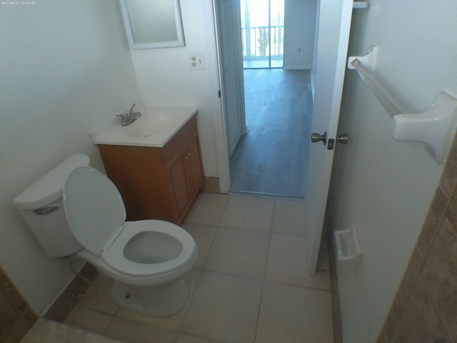 bathroom featuring tile patterned floors, vanity, and toilet