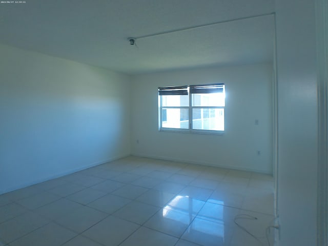 spare room with light tile patterned floors