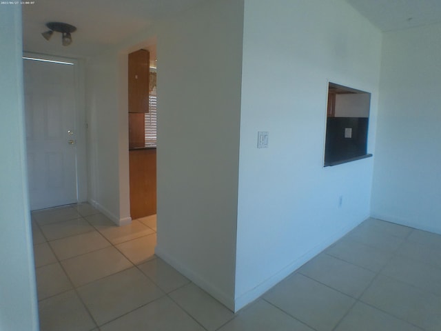 hall with light tile patterned floors