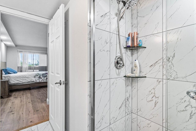 interior details with tiled shower and hardwood / wood-style floors