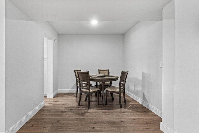 dining space featuring wood-type flooring