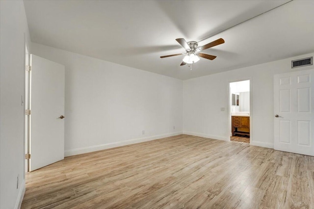 3601 Inverrary Dr Unit 102, Lauderhill, FL 33319 - unfurnished bedroom with light wood-type flooring, baseboards, ensuite bath, and a ceiling fan