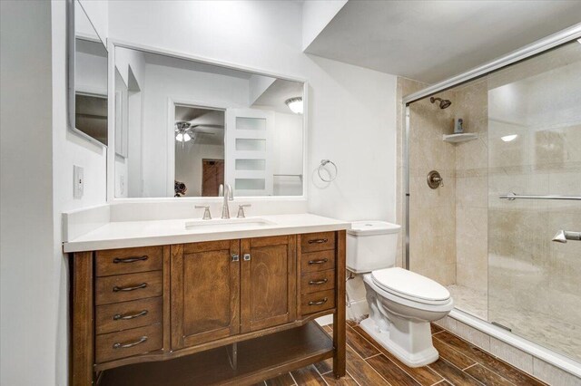 3601 Inverrary Dr Unit 102, Lauderhill, FL 33319 - full bathroom featuring toilet, a ceiling fan, a shower stall, vanity, and wood finished floors